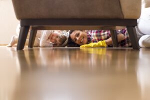 pretty caucasian female and little child cleaning home together and having fun
