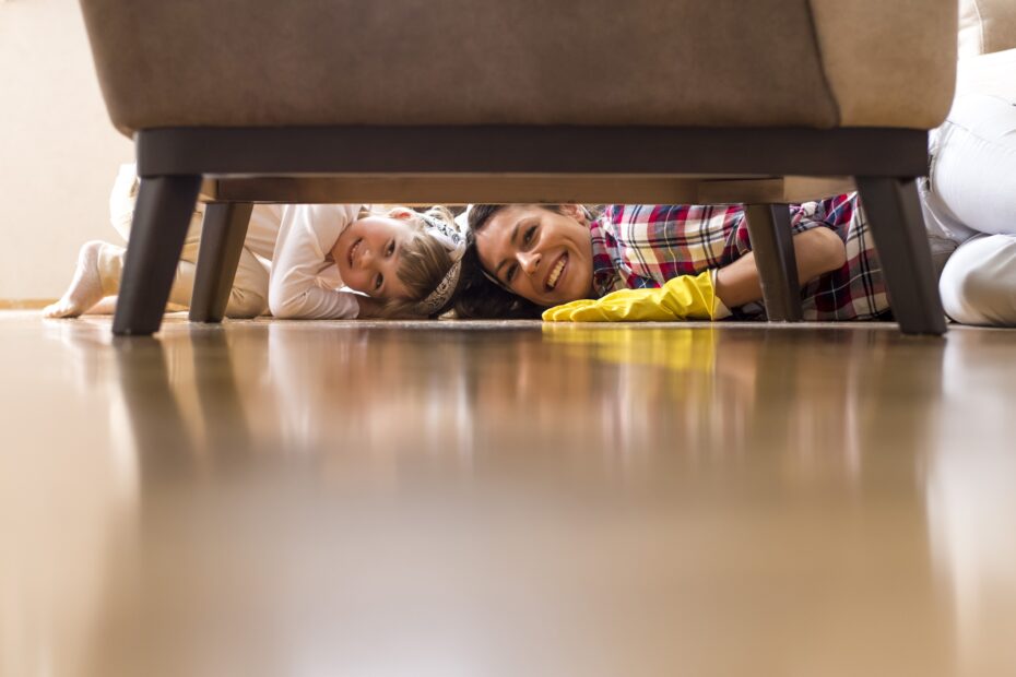 pretty caucasian female and little child cleaning home together and having fun